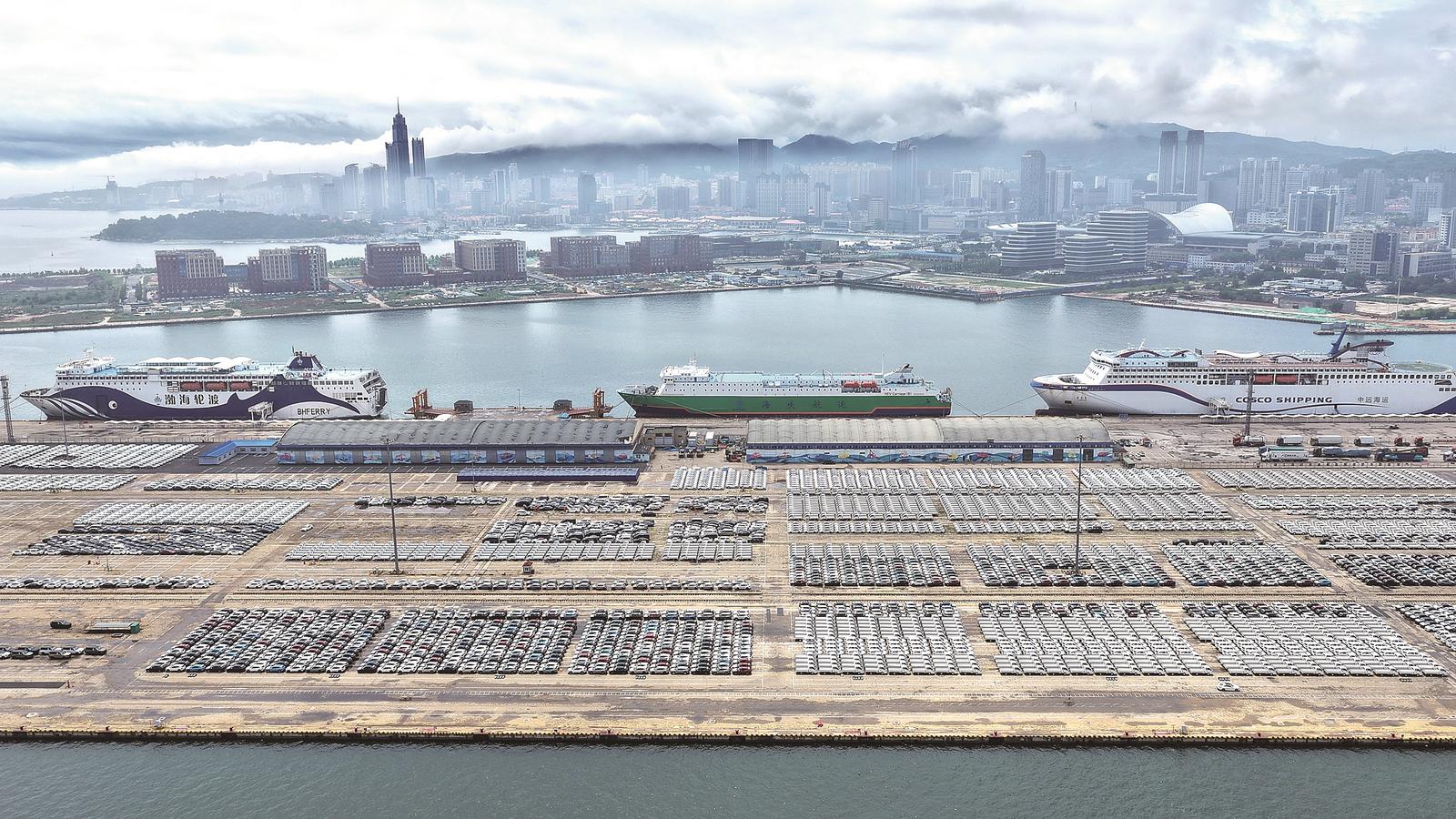7月14日,大批国产汽车在山东港口烟台港等待装船出口(无人机照片)。唐克 摄