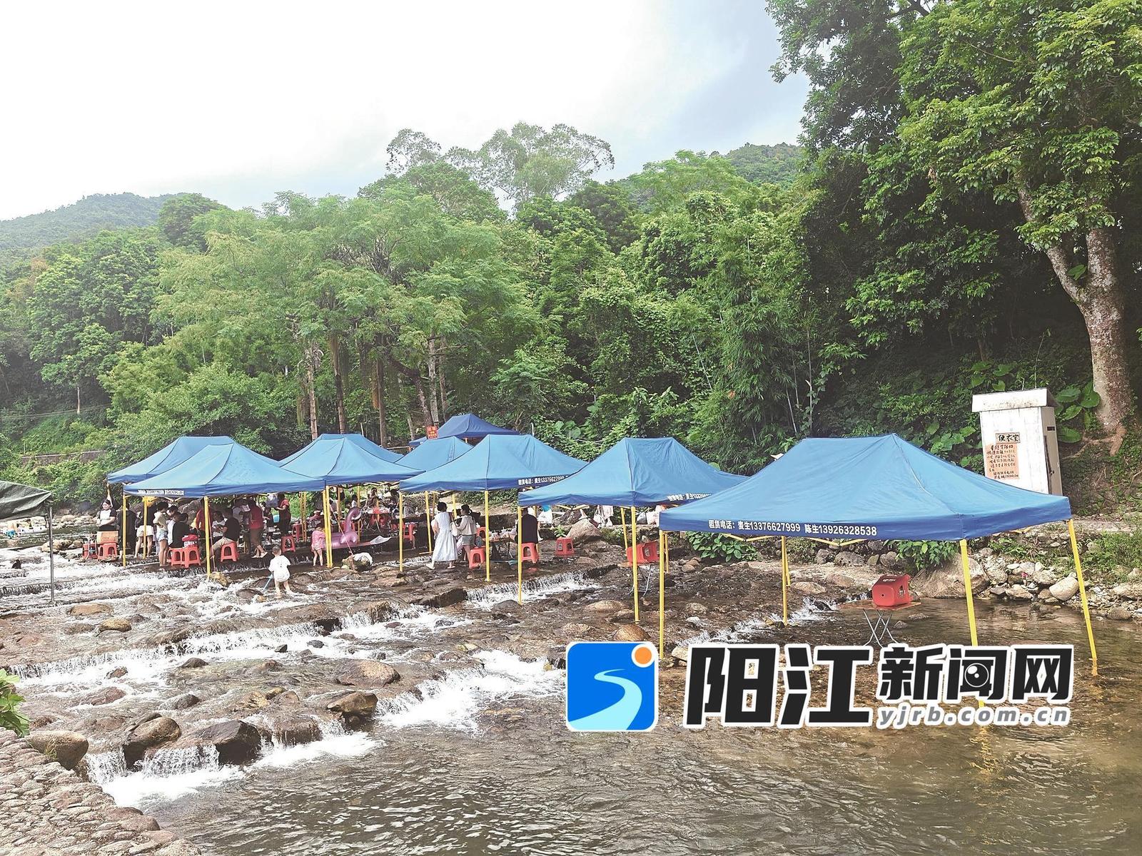 游客在雨林河上搭帐篷休闲娱乐。